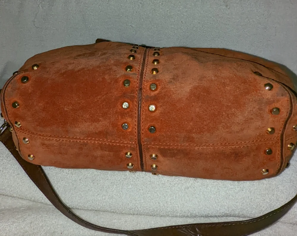 Michael Kors orange suede studded slouchy shoulder bag.